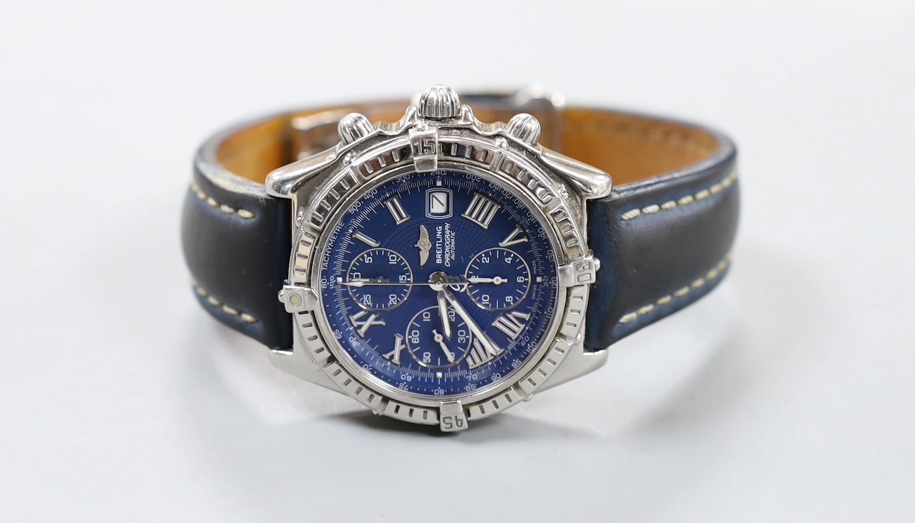 A gentleman's modern stainless steel Breitling chronograph automatic wrist watch, with blue Roman dial, on leather strap with deployment clasp, no box or papers.